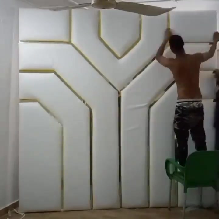 Spyll team installing an upholstered headboard