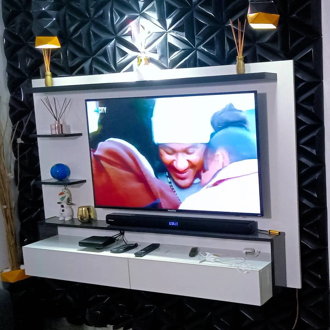 Black geometric TV wall and white floating media unit